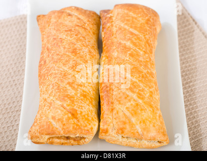 Sausage Rolls - Freshly baked sausage rolls - sausage meat wrapped in puff pastry. Stock Photo