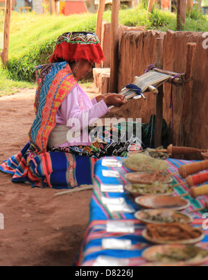 A Quechua lady working on a traditional weaving design from Cuzco, Peru Stock Photo
