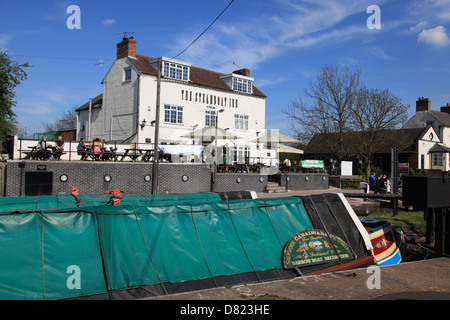 An historic narrowboat on the Erewash Canal at Trent Lock with the Steamboat Inn in the background Stock Photo