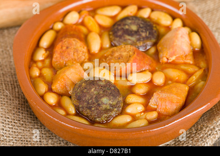 Fabada Asturiana - Spanish bean stew with chorizo, ham and blood sausage. Stock Photo