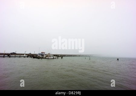 Queen Isabella Bridge disappears into the fog over the causeway at South Padre Island, Texas, USA Stock Photo