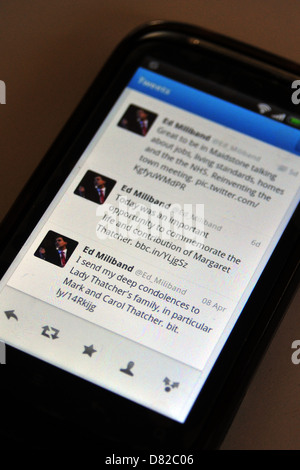 Tweets displayed on a mobile phone screen following the death and funeral of former British Prime Minister Margaret Thatcher. Stock Photo