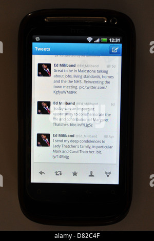 Tweets displayed on a mobile phone screen following the death and funeral of former British Prime Minister Margaret Thatcher. Stock Photo