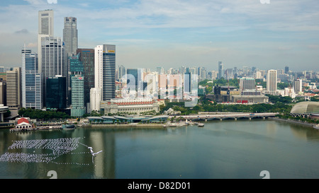 Aerial view of Singapore's Central Business District with high rise office buildings and Marina Bay waters in the foreground. Stock Photo