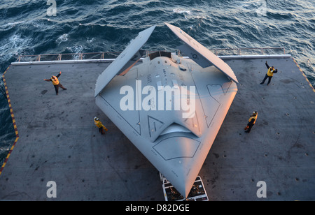 Sailors move an X-47B. Stock Photo