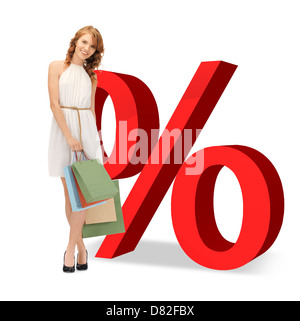 woman with shopping bags and percent signs Stock Photo