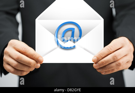 man in suit holding envelope with email sign Stock Photo