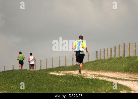 Runners on the Three Forts Challenge on their way to Chanctonbury Ring in West Sussex. Stock Photo