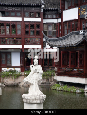 Huxinting tea house and statue at the entrance to Yuyuan Garden in the old city of Shanghai, China Stock Photo
