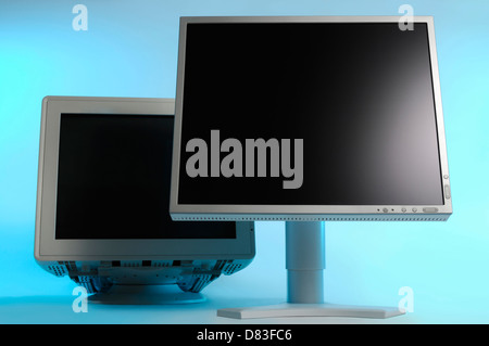 New LCD display and an old CRT monitor behind it. Technology, computers and electronics concept. Stock Photo