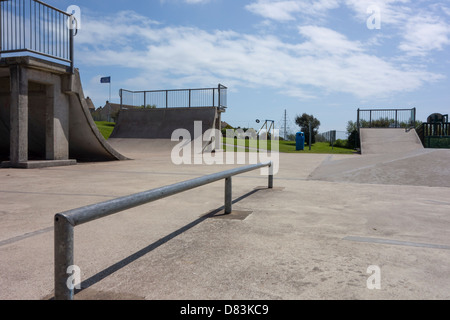 View of a skate park within a public playground in the UK. Stock Photo