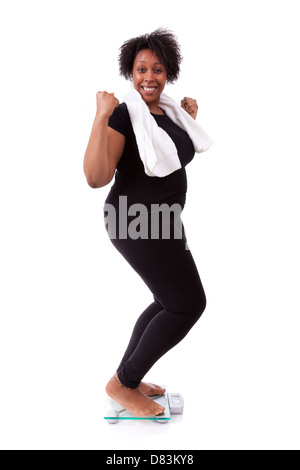 African American woman cheering on scale isolated over white background - African people Stock Photo