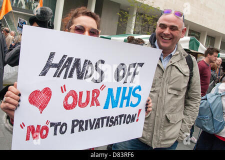London, UK. 18th May 2013. London.  Two protesters with their placard demanding that the government leaves the NHS alone. Credit:  Paul Davey / Alamy Live News Stock Photo