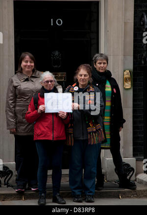 London, UK. 18th May 2013. NHS Campaigners Sarah Cox (2nd L), Eve Acorn (2nd R) and Gillian Lewis (R) pose with a letter addressed to David Cameron, calling to an end to NHS cuts and privitisation Credit:  Andy Thornley / Alamy Live News Stock Photo