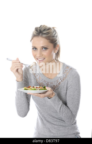 Model Released. Young Woman Eating Chicken Salad Stock Photo