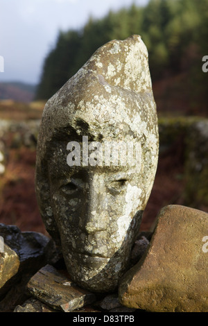 Stone sculpted human faces embedded in a dry stone dyke by Matt Baker, Galloway Forest Park, Dumfries & Galloway, Scotland Stock Photo