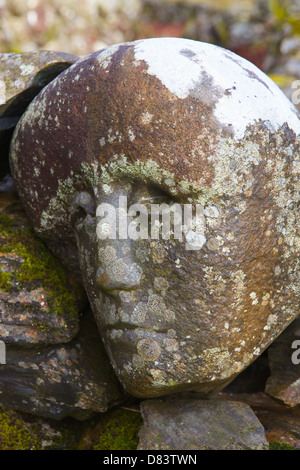 Stone sculpted human faces embedded in a dry stone dyke by Matt Baker, Galloway Forest Park, Dumfries & Galloway, Scotland Stock Photo