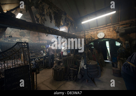 Blacksmith working in a traditional forge. Stock Photo