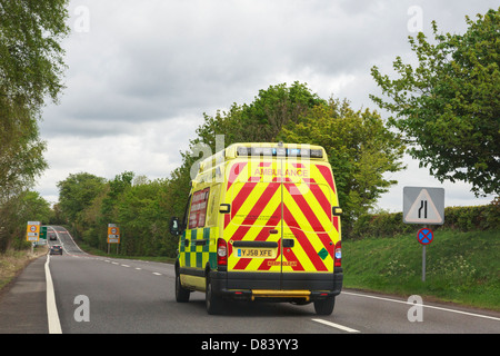 View through a windscreen of an ambulance with blue lights flashing rushing to an emergency along A5 road. England, UK, Britain Stock Photo