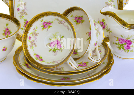 Close-up of dainty antique china tea cups, saucers and small plates. Stock Photo