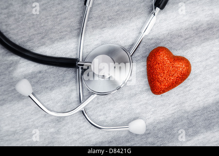 Stethoscope and heart symbol on a table with shadows Stock Photo