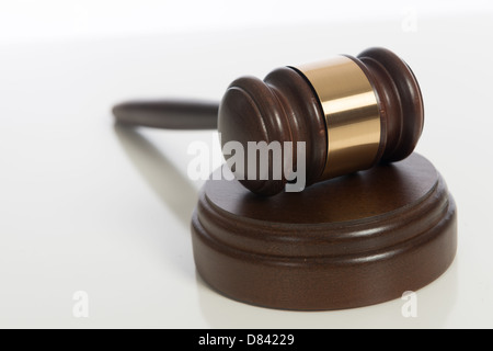 A brown wooden judge's gavel on a white background Stock Photo