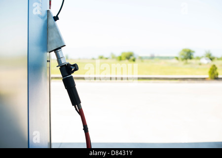 Device for charging gas car on gas station. Stock Photo