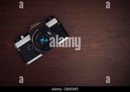 Vintage film camera on a wooden table Stock Photo