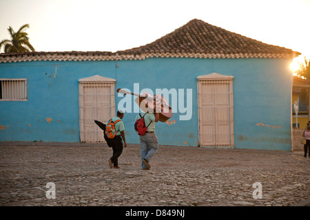 street musician with Double bass on their way home in the old town of Trinidad, Cuba, Caribbean Stock Photo