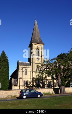 Car passing in front of St Peter's church , Southborough Common , near Tunbridge Wells , Kent , England Stock Photo