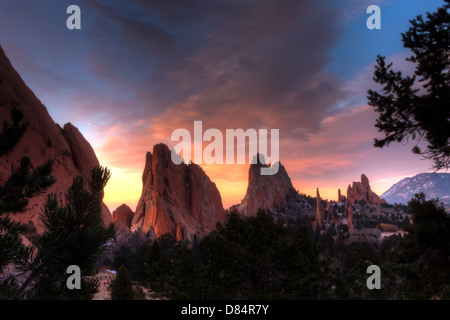 Beautiful HDR image of purple and orange sunrise clouds over red rock formations at Garden of the Gods, Colorado Stock Photo