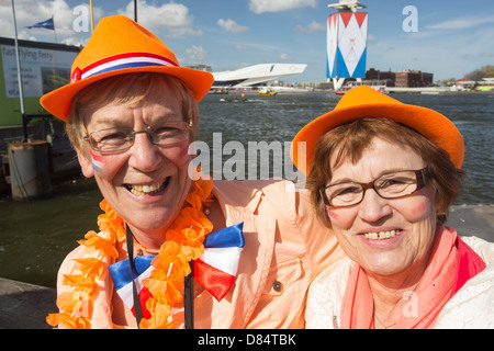 Dutch woman celebrating on Queens day in Amsterdam, Netherlands when the queen abdication to be replaced by the king. Stock Photo