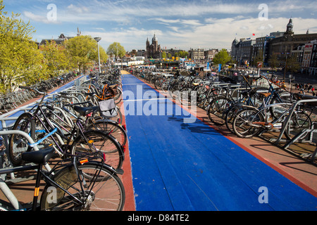 Bikes in bike racks in amsterdam, Netherlands. A huge percentage of the population cycle in this flat, low lying country. Stock Photo