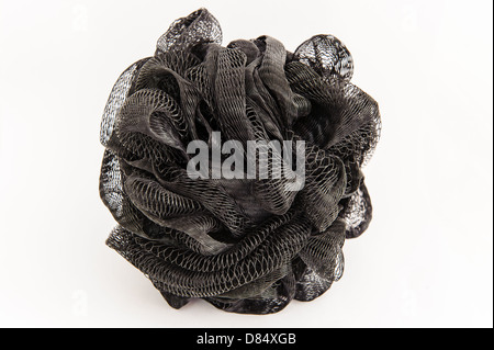 A new plastic black exfoliating mesh sponge with a loop for drying isolated on a white background Stock Photo