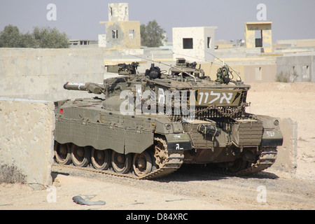 An Israel Defense Force Merkava Mark II main battle tank demonstrates urban warfare techniques. Stock Photo