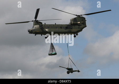 ROYAL AIR FORCE CHINOOK CARRYING LOAD AND GUN Stock Photo