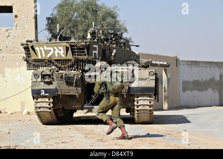 An Israel Defense Force Merkava Mark II main battle tank demonstrates urban warfare techniques. Stock Photo
