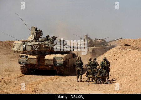 An Israel Defense Force Merkava Mark IV main battle tank exercise with infantry forces. Stock Photo
