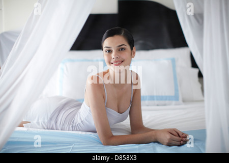 young woman posing on bed. Stock Photo