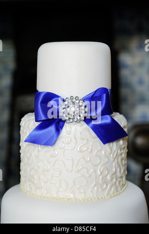 Closeup of blue and white wedding cake at reception