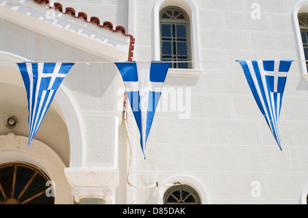 Greek flags fly outside the church of Metropolis Rethymno Stock Photo