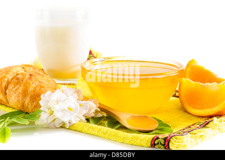 Breakfast with honey, milk and oranges Stock Photo