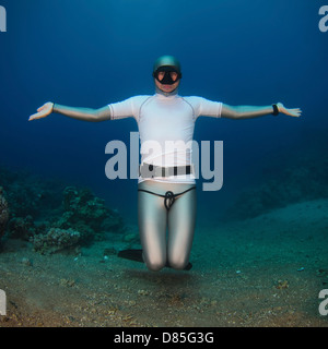 Freediver underwater in the Red Sea. Photographed in Aqaba, Jordan. Model Release Available. Stock Photo