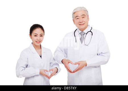 Two oriental doctor making a gesture of heart shape Stock Photo