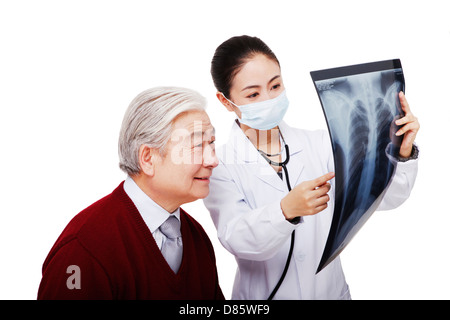 The doctor put the patient to produce X ray film Stock Photo