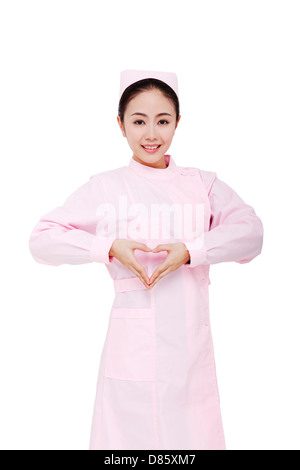 The young female nurses make heart gesture Stock Photo