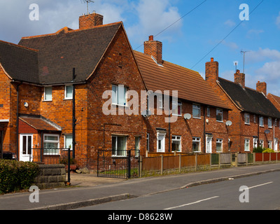 Former council or social housing in Clipstone a former mining village Nottinghamshire England UK with satellite dishes on walls Stock Photo