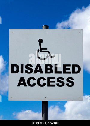 Disabled Access sign with wheelchair logo and blue sky behind Stock Photo