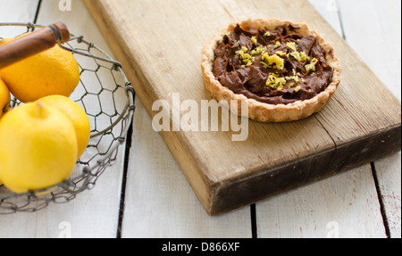 tartlet with chocolate cream and lemon in a basket Stock Photo