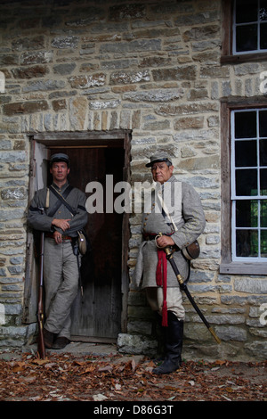 American civil war reenactor in uniform costume near old period building Stock Photo
